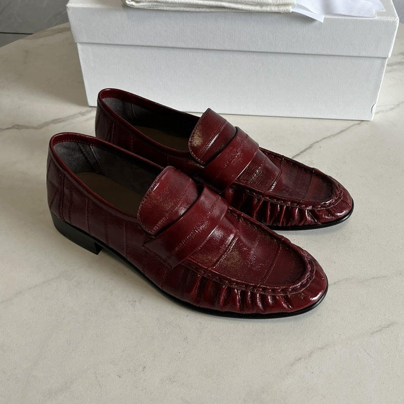 Eel skin loafers for women by Rossie Viren, showcasing sleek, textured shoes with a modern design and slip-on style.