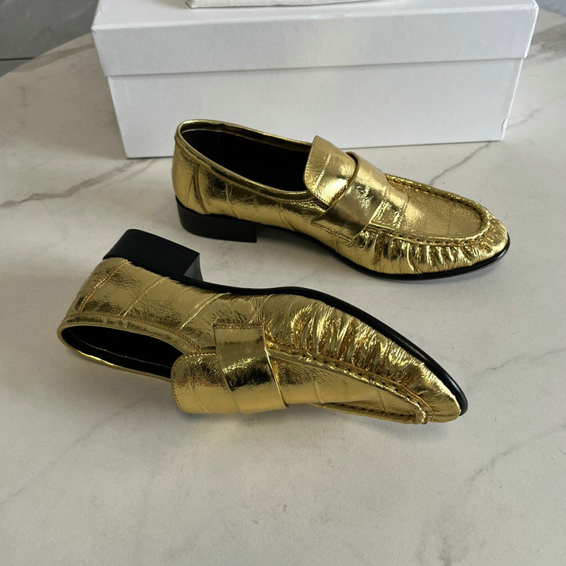 Eel skin loafers for women by Rossie Viren, featuring sleek black shoes with a smooth finish and classic slip-on design.
