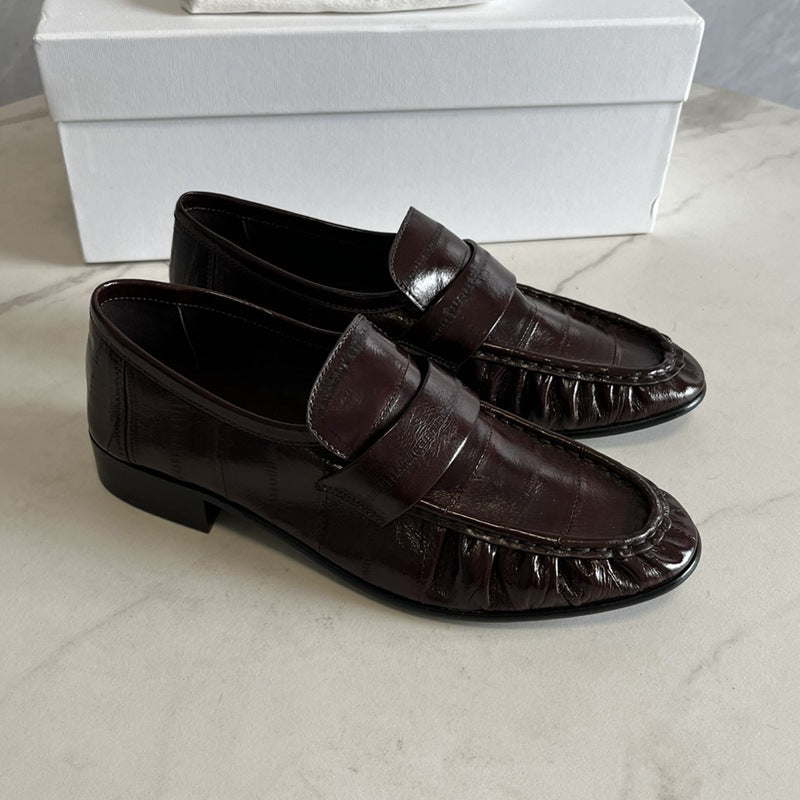 Eel skin loafers for women by Rossie Viren, showcasing stylish black shoes with smooth eel skin texture and classic slip-on design.