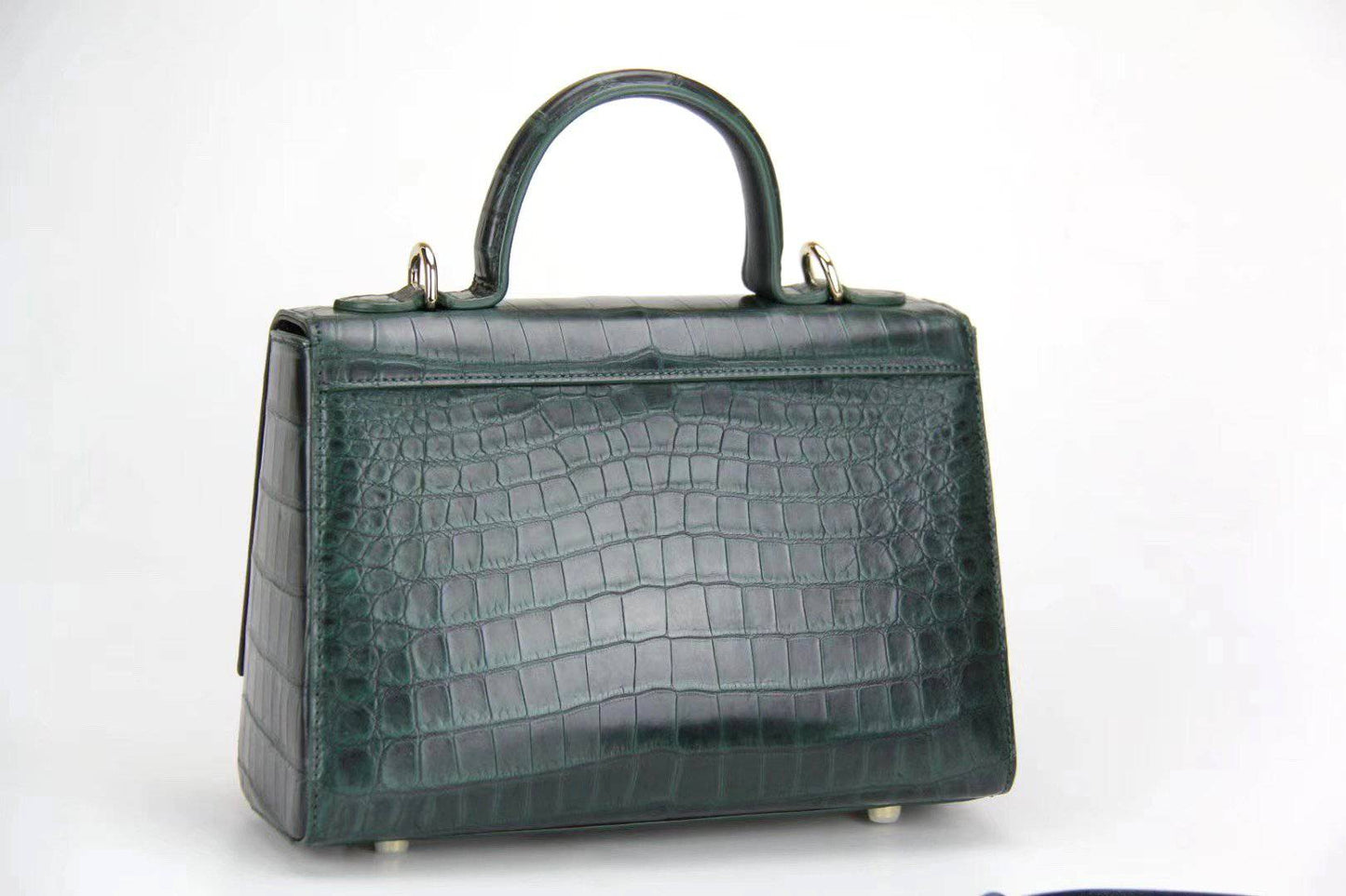 Women's crocodile leather messenger handbag with crossbody strap and top handle by Rossie Viren, showcasing sleek and textured design.